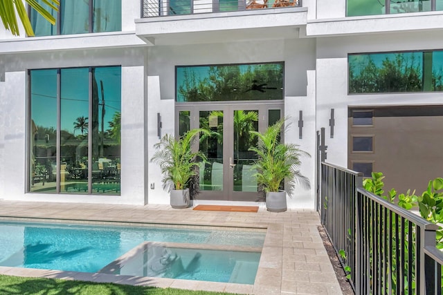 exterior space with a patio area, french doors, and a balcony