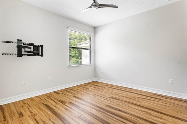 spare room featuring hardwood / wood-style flooring, a textured ceiling, and ceiling fan