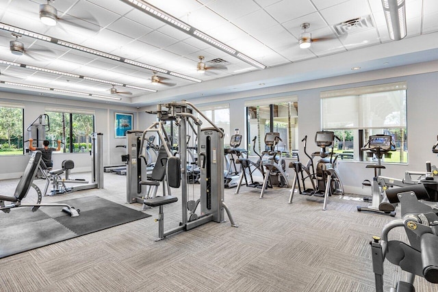 exercise room featuring light carpet