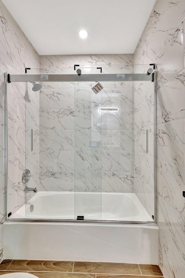 bathroom featuring shower / bath combination with glass door