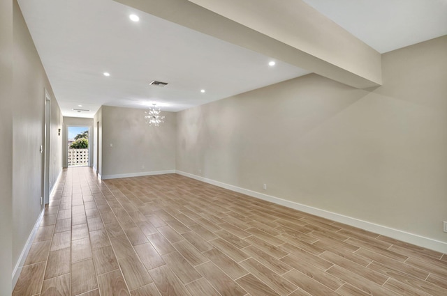 empty room featuring a chandelier