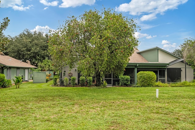 view of front of property featuring a sunroom and a front yard