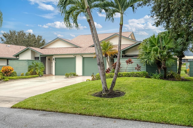 single story home with a garage and a front lawn