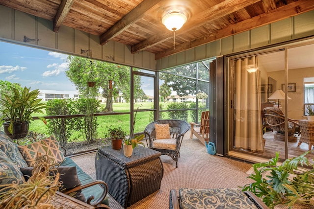 sunroom / solarium featuring beamed ceiling, a wealth of natural light, and wood ceiling