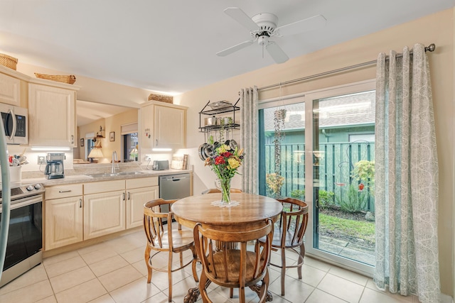 dining room with ceiling fan, a wealth of natural light, sink, and light tile patterned floors