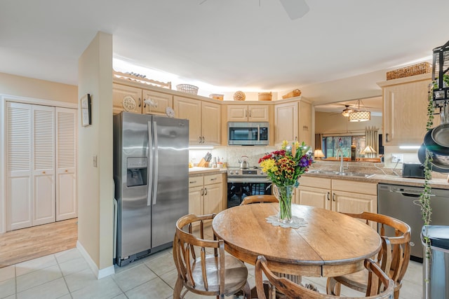 kitchen featuring sink, light brown cabinets, ceiling fan, and appliances with stainless steel finishes