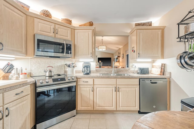 kitchen featuring light brown cabinetry, sink, and appliances with stainless steel finishes