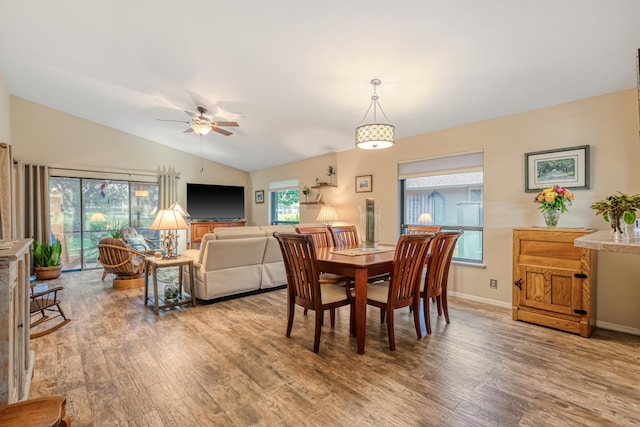 dining area with ceiling fan, lofted ceiling, and hardwood / wood-style floors