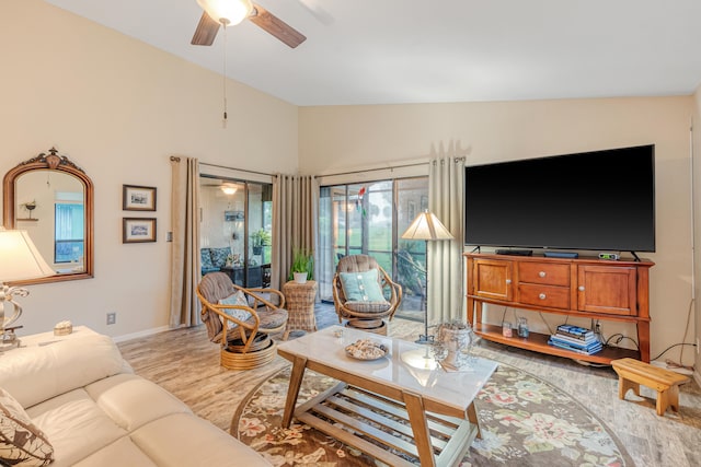 living room featuring vaulted ceiling, ceiling fan, and light hardwood / wood-style floors