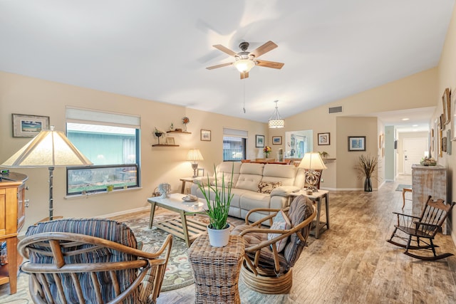 living room featuring vaulted ceiling, light hardwood / wood-style floors, and ceiling fan