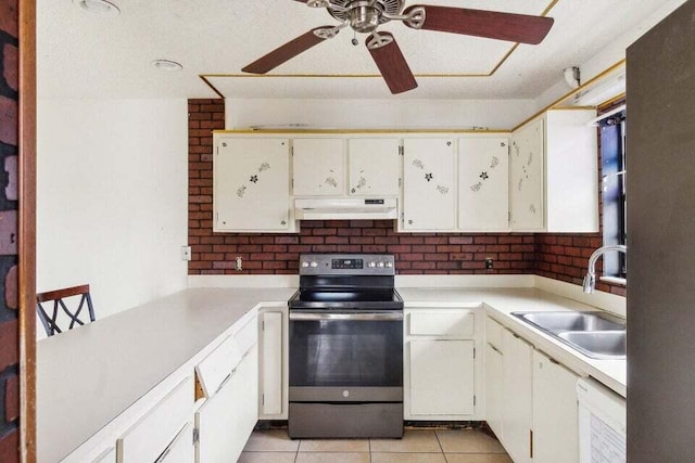 kitchen with white cabinets, sink, light tile patterned floors, and stainless steel range with electric cooktop