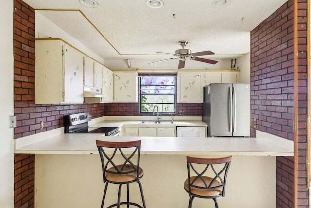 kitchen with stainless steel appliances, kitchen peninsula, and a breakfast bar area