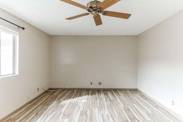 unfurnished room with ceiling fan, a textured ceiling, and light hardwood / wood-style floors