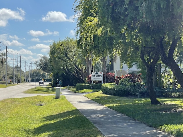 view of home's community with a yard