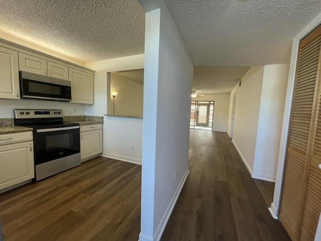 kitchen featuring white cabinetry, dark hardwood / wood-style floors, a textured ceiling, and appliances with stainless steel finishes