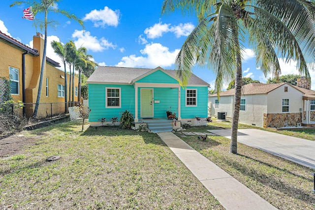 view of front of house featuring central AC and a front lawn