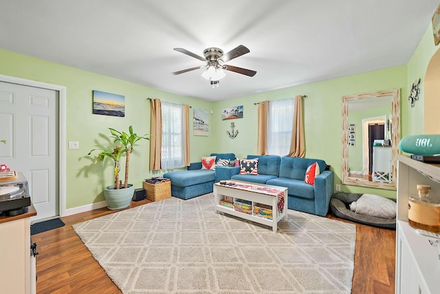 living room with hardwood / wood-style flooring, plenty of natural light, and ceiling fan