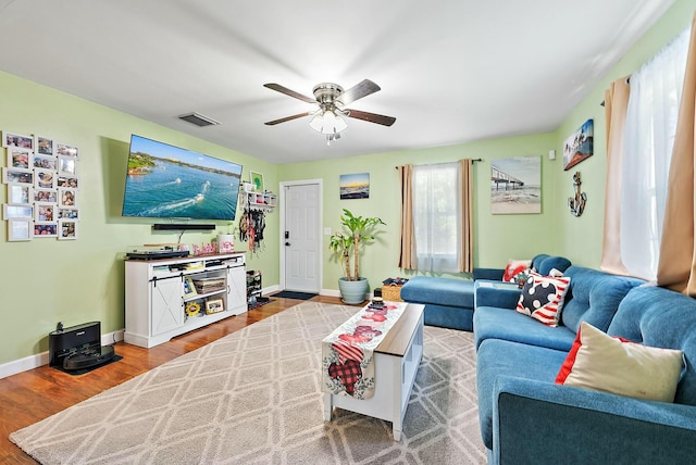 living room featuring hardwood / wood-style floors and ceiling fan