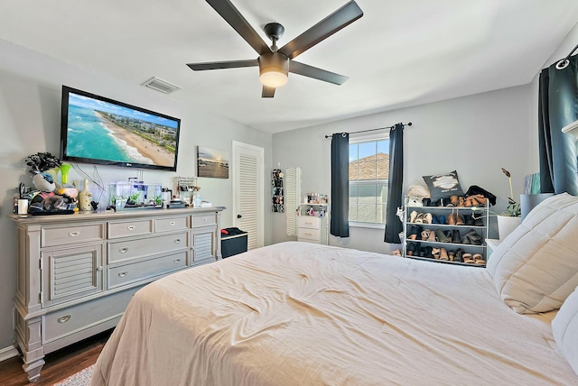 bedroom with ceiling fan and dark hardwood / wood-style floors