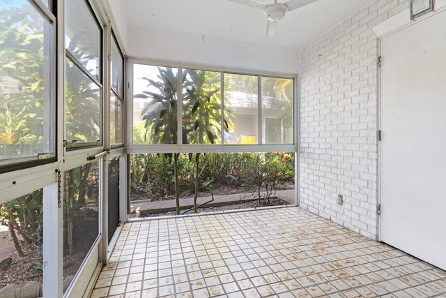 unfurnished sunroom with ceiling fan