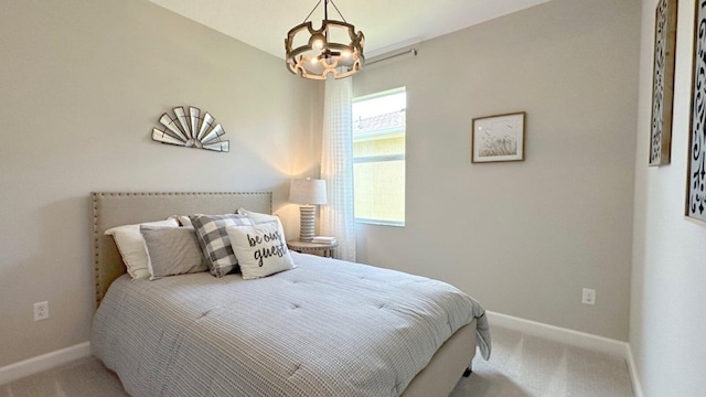 bedroom featuring a chandelier and carpet