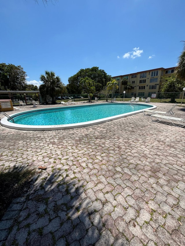 view of swimming pool with a patio area