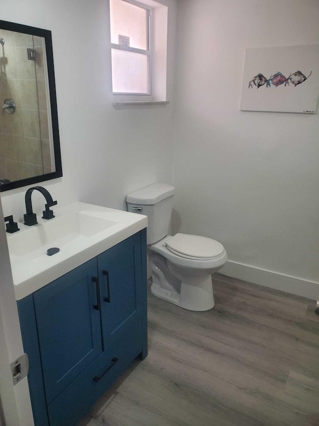 bathroom featuring vanity, hardwood / wood-style flooring, and toilet