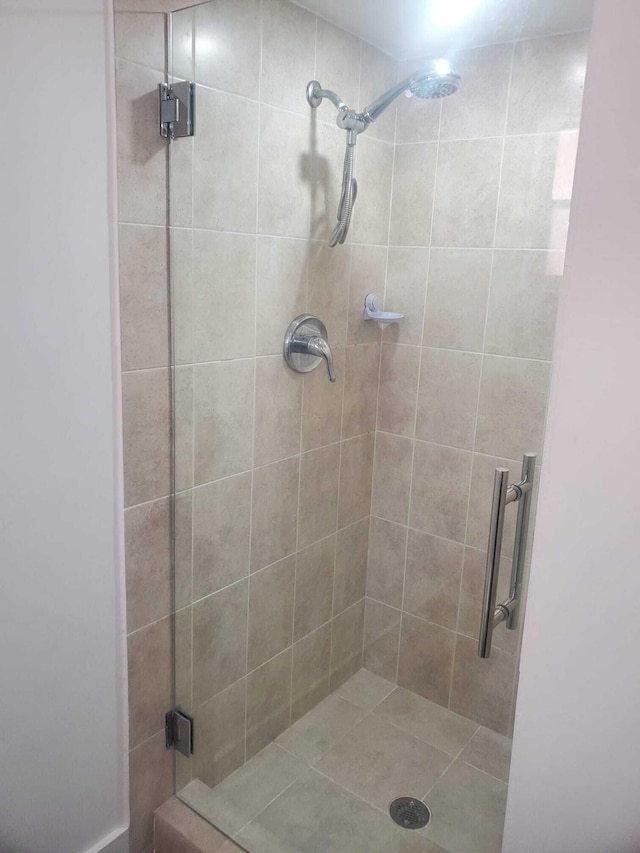 bathroom with a shower with shower door