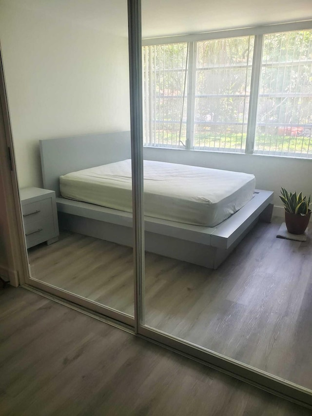 bedroom with dark hardwood / wood-style flooring