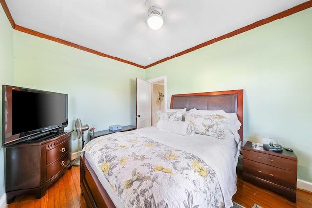 bedroom with wood-type flooring, ornamental molding, and ceiling fan