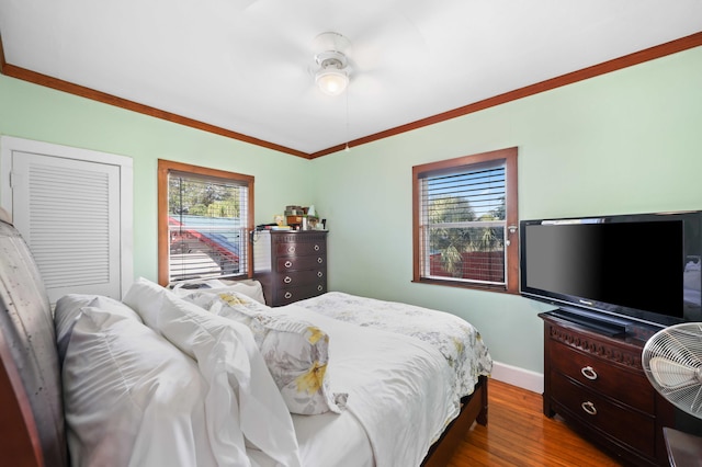 bedroom with hardwood / wood-style flooring and ornamental molding