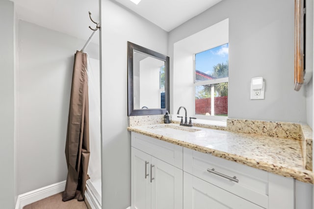 bathroom with walk in shower and vanity