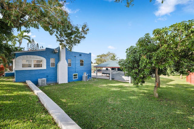 view of home's exterior featuring cooling unit and a lawn