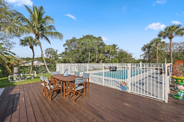 wooden deck with a fenced in pool