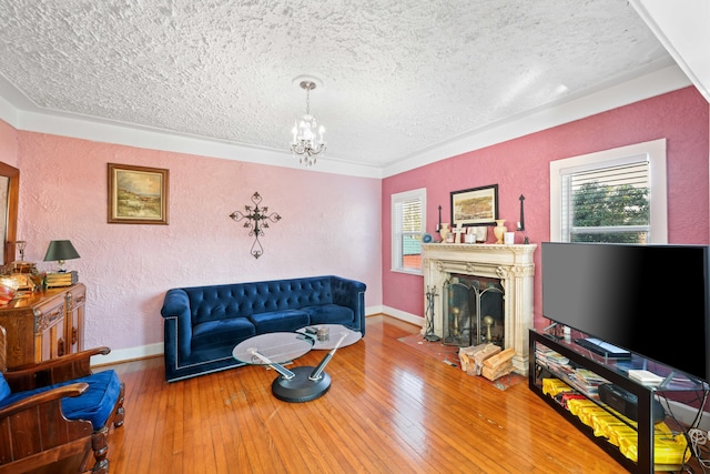 living room with an inviting chandelier, wood-type flooring, and a textured ceiling