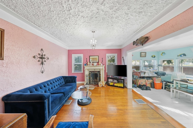 living room featuring hardwood / wood-style floors, a notable chandelier, and a textured ceiling