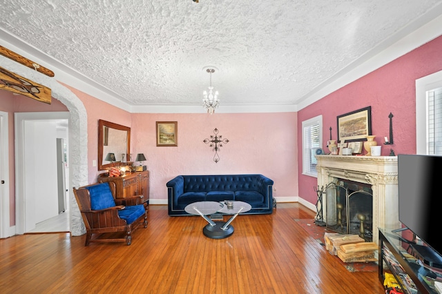 living room featuring wood-type flooring and a textured ceiling