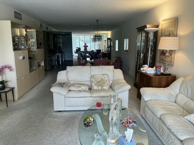 living area with carpet floors, visible vents, and a textured ceiling