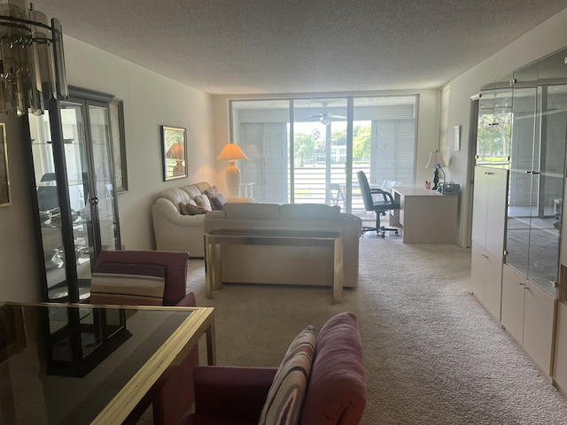 bedroom featuring carpet, a textured ceiling, access to exterior, and a desk