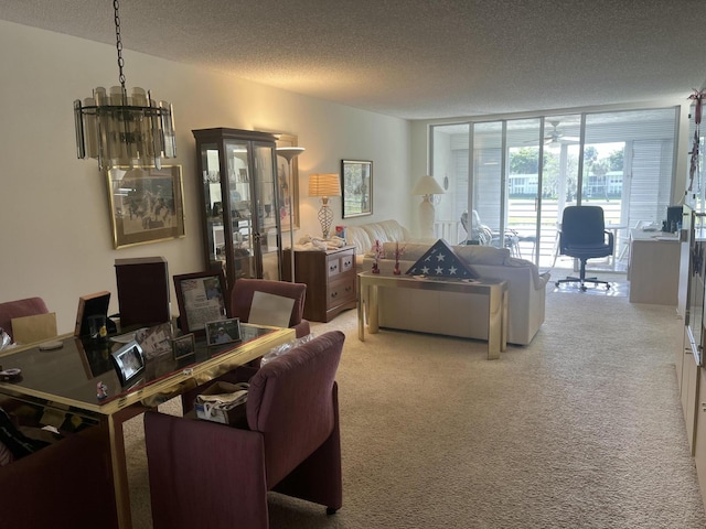 carpeted living area featuring an office area and a textured ceiling