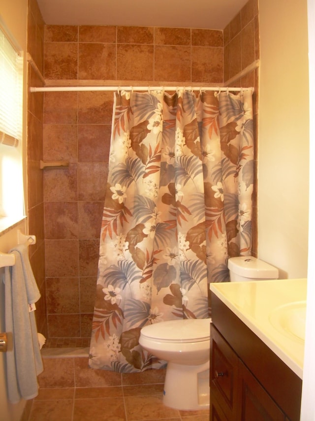 bathroom with walk in shower, tile patterned floors, vanity, and toilet