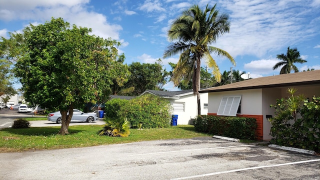 view of side of property with a yard