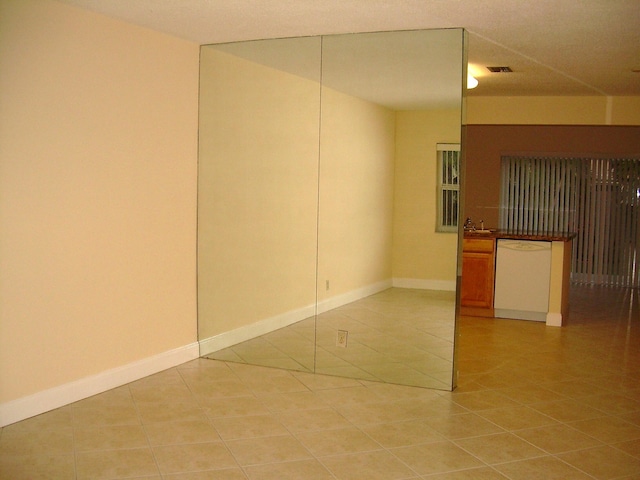 spare room with tile patterned flooring and sink