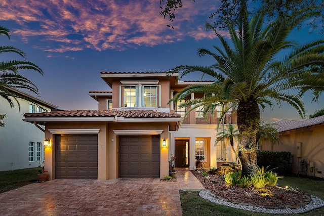 mediterranean / spanish-style home with a balcony and a garage