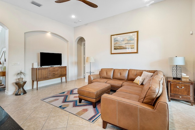 tiled living room with ceiling fan