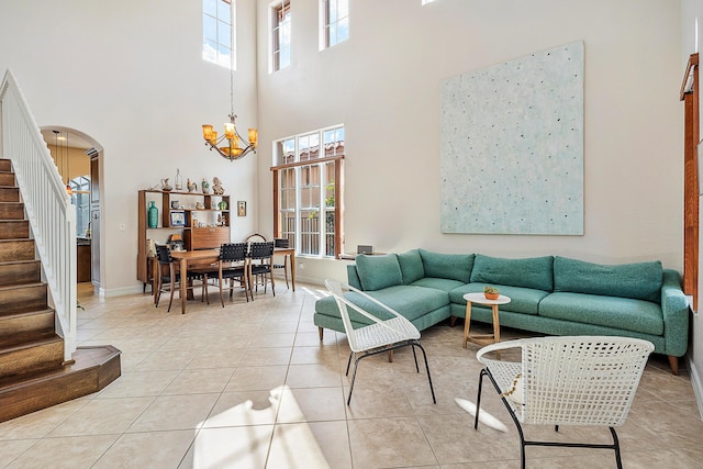 tiled living room featuring an inviting chandelier and plenty of natural light