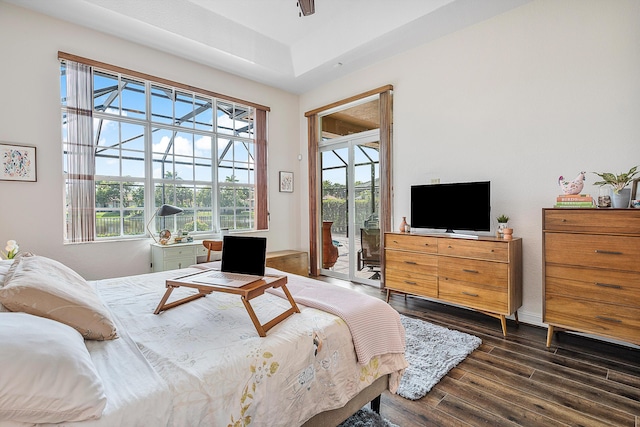 bedroom with access to exterior and dark hardwood / wood-style flooring