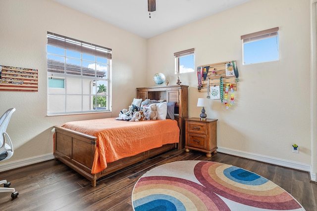 bedroom with dark hardwood / wood-style floors and ceiling fan