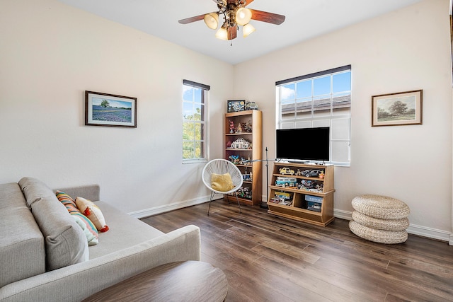 living room with ceiling fan and dark hardwood / wood-style flooring