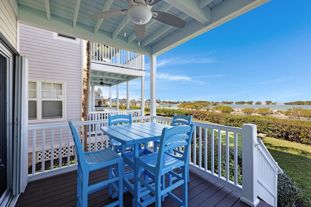 wooden terrace with ceiling fan and outdoor dining area
